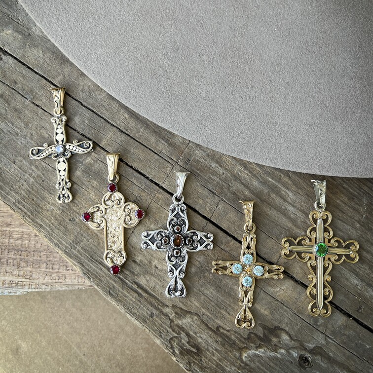A collection of golden cross pendants